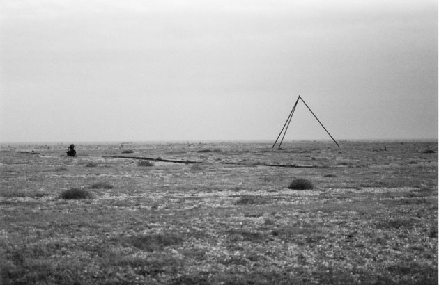 a bare monochrome terrain, with a triangle