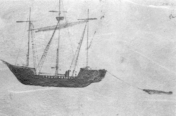 on a rock, perhaps, a three-masted vessel, towing